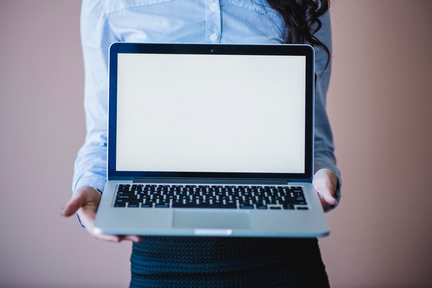 Woman showing laptop screen