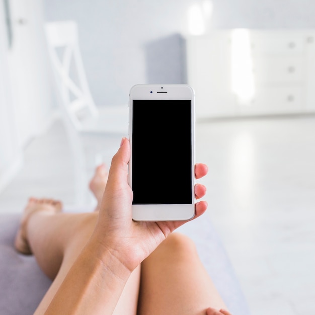 A woman showing mobile phone with blank screen