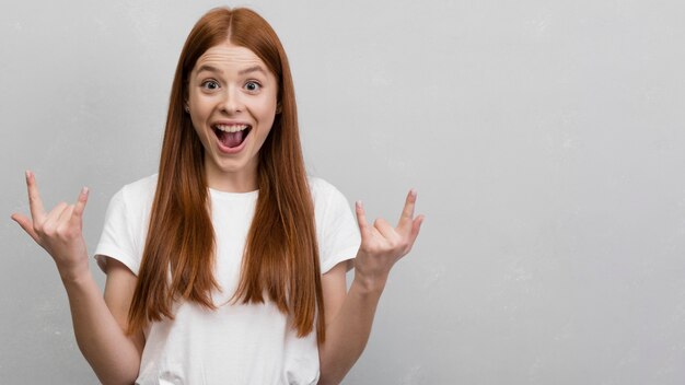 Woman showing rock sign front view