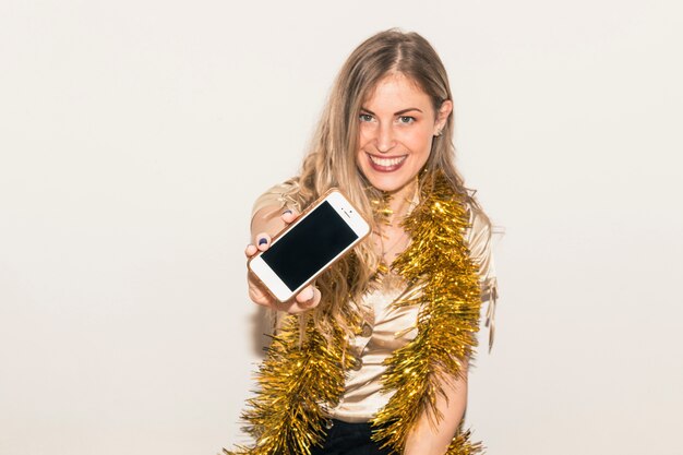 Woman showing smartphone in hand