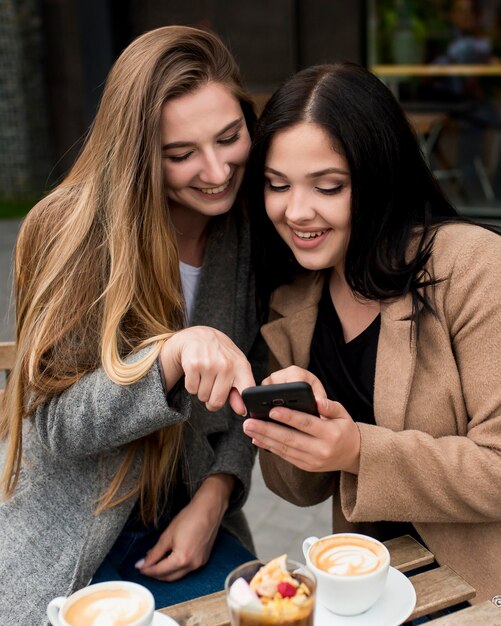 Woman showing something on her phone to her friend