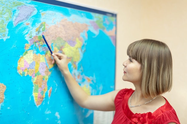 Free photo woman showing something on  world map