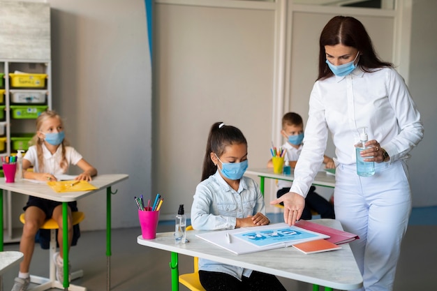 Woman showing virus precautions to a kid