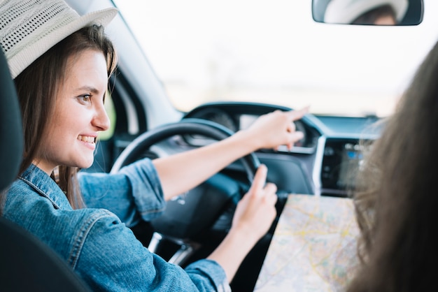 Woman showing way to passenger