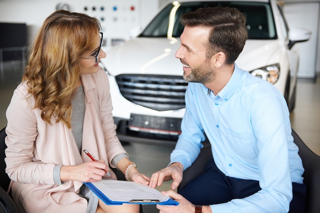 Woman signing contract with her partner