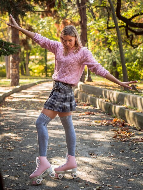 Woman silly posing on street with roller skates