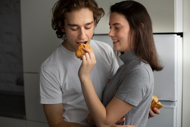 Woman similing while feeding boyfriend