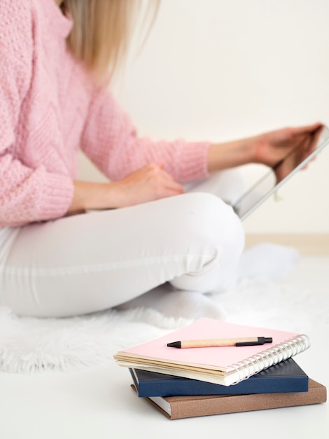 Woman sitting in bed and using digital tablet