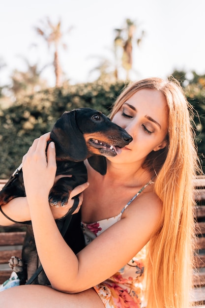 Woman sitting on bench with her dog