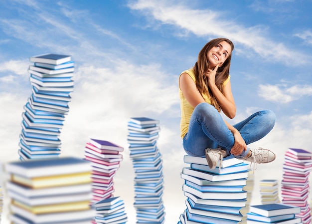 Woman sitting on books