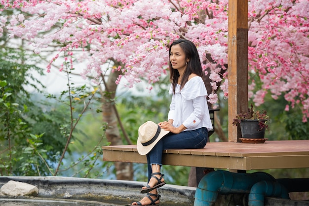 The woman sitting under the cherry tree