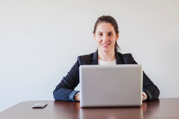 Woman sitting at desk working on laptop