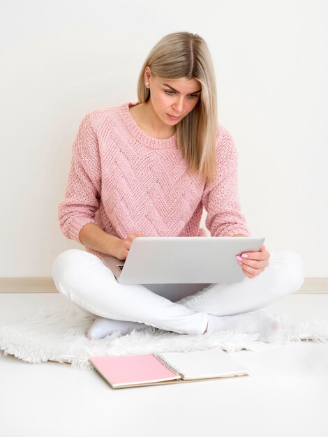 woman sitting on the floor and attending a course