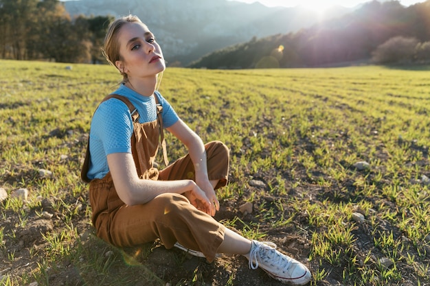 Woman sitting on the ground in sunlight