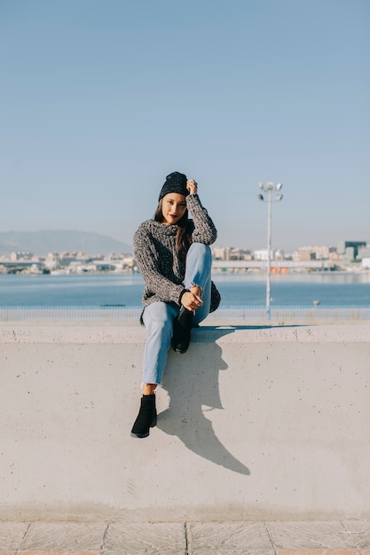 Woman sitting in harbor area