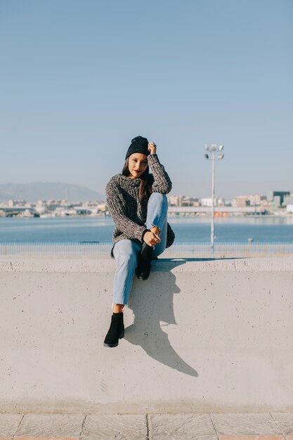 Woman sitting in harbor area