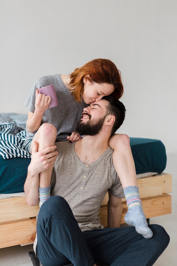 Free Photo woman sitting on her boyfriend shoulders