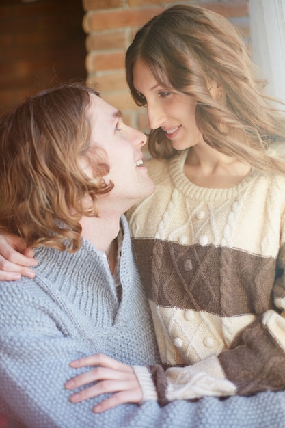 Woman sitting on her boyfriend