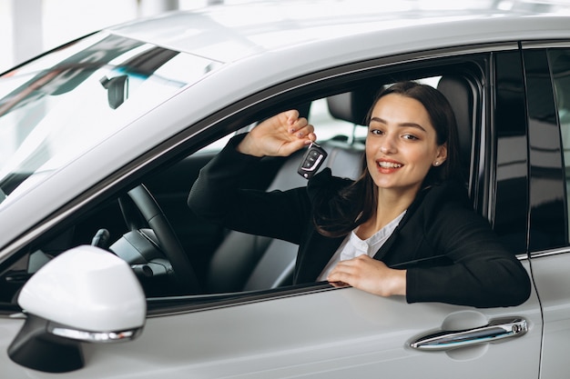 Woman sitting inside a car and holding keys