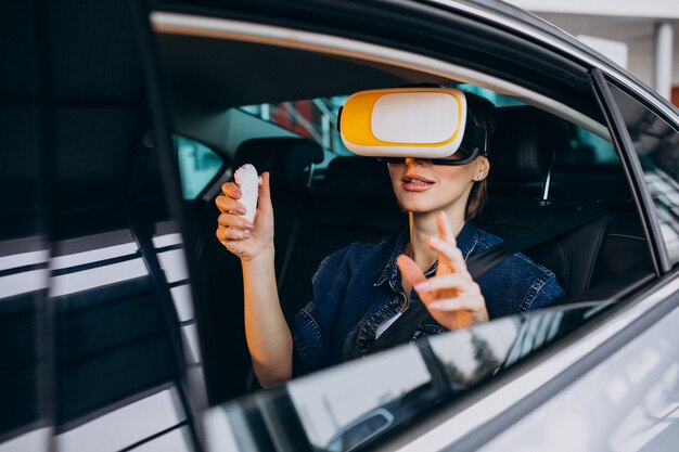 Woman sitting inside a car wearing vr glasses