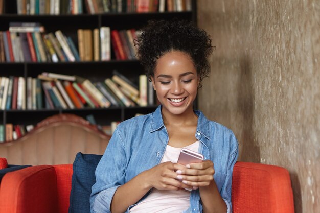 Woman sitting in a library on a couch