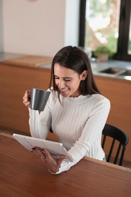 Woman sitting and looking on tablet