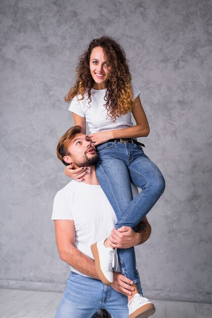 Woman sitting on man shoulder 