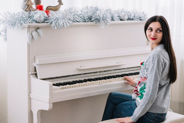 Woman sitting near piano 