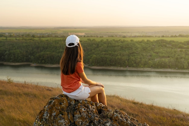 Woman sitting outdoors full shot