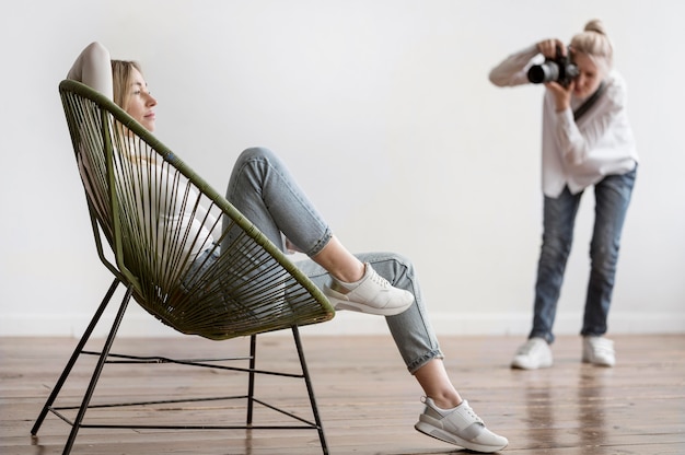 Женщина сидит и фотограф фотографировать