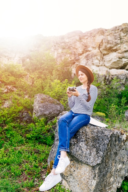 Woman sitting on rock in nature