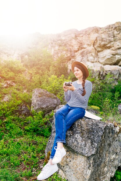 Woman sitting on rock in nature