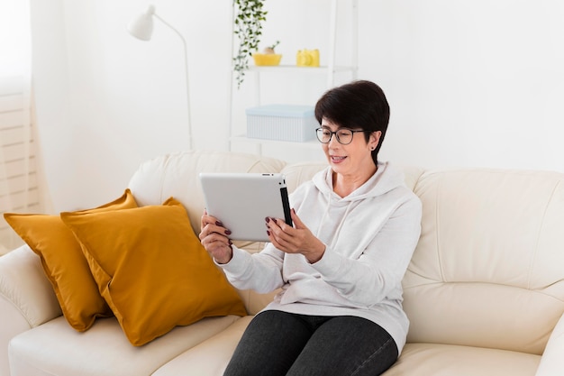 Woman sitting on sofa with table