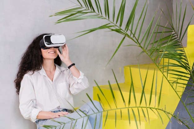 Woman sitting on the stairs using vr