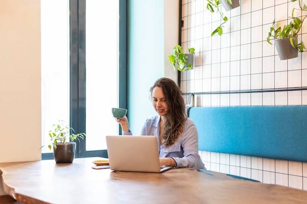 Free photo woman sitting at table medium shot