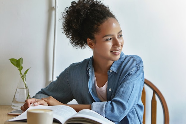 Woman sitting at a table with a book