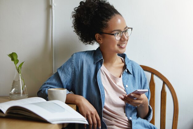 Woman sitting at a table with a book