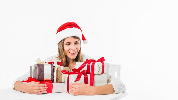 Woman sitting at table with gift boxes 