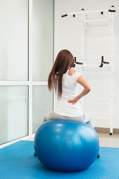 Woman sitting on therapy ball