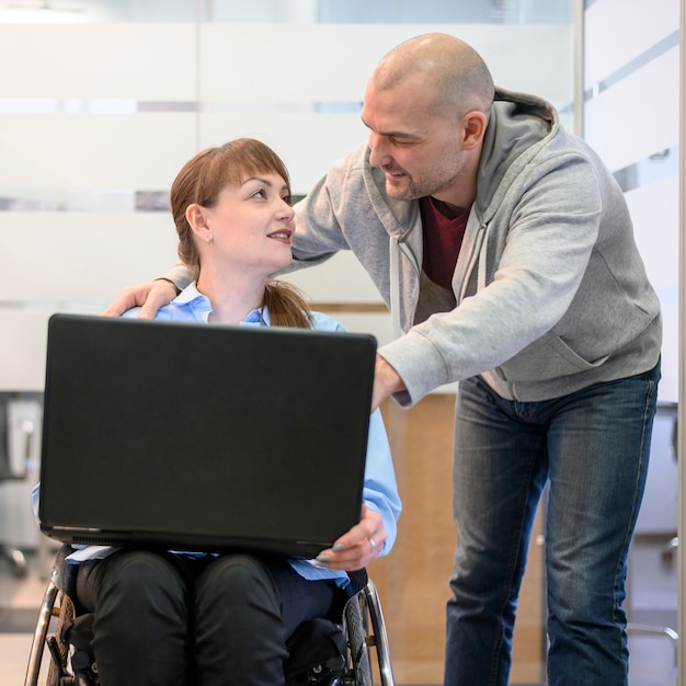 Free photo woman sitting in wheelchair and friend