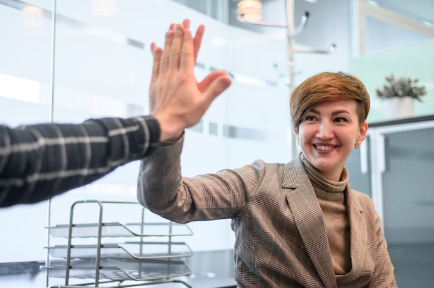 Woman sitting in wheelchair high five