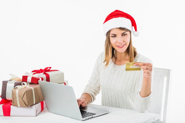 Woman sitting with credit card at table 