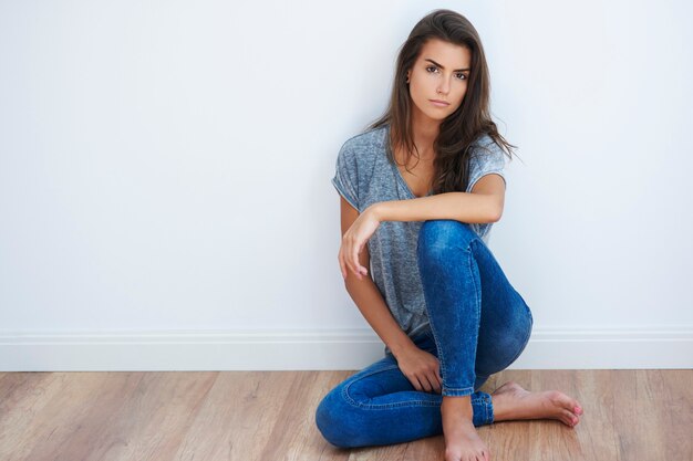 Woman sitting on the wooden floor