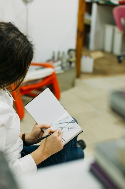 Woman sketching with fine liner