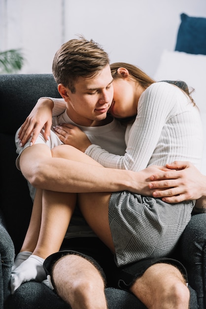 Free photo woman sleeping on man lap in armchair