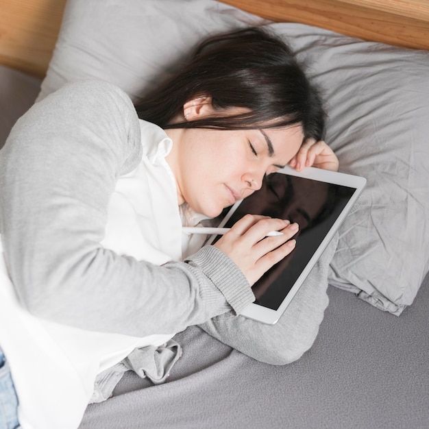 Woman sleeping with tablet