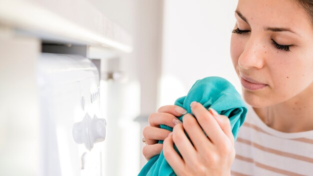 Woman smelling clean laundry close up
