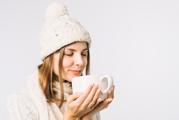 Woman smelling hot drink