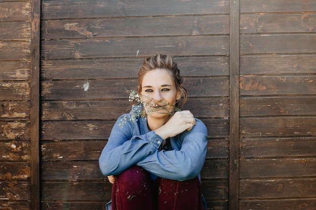 Woman smelling wild flowers