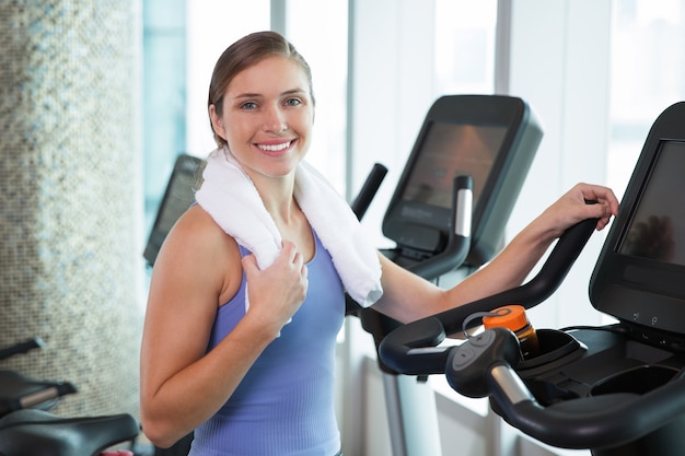 Woman smiling on an elliptical brace